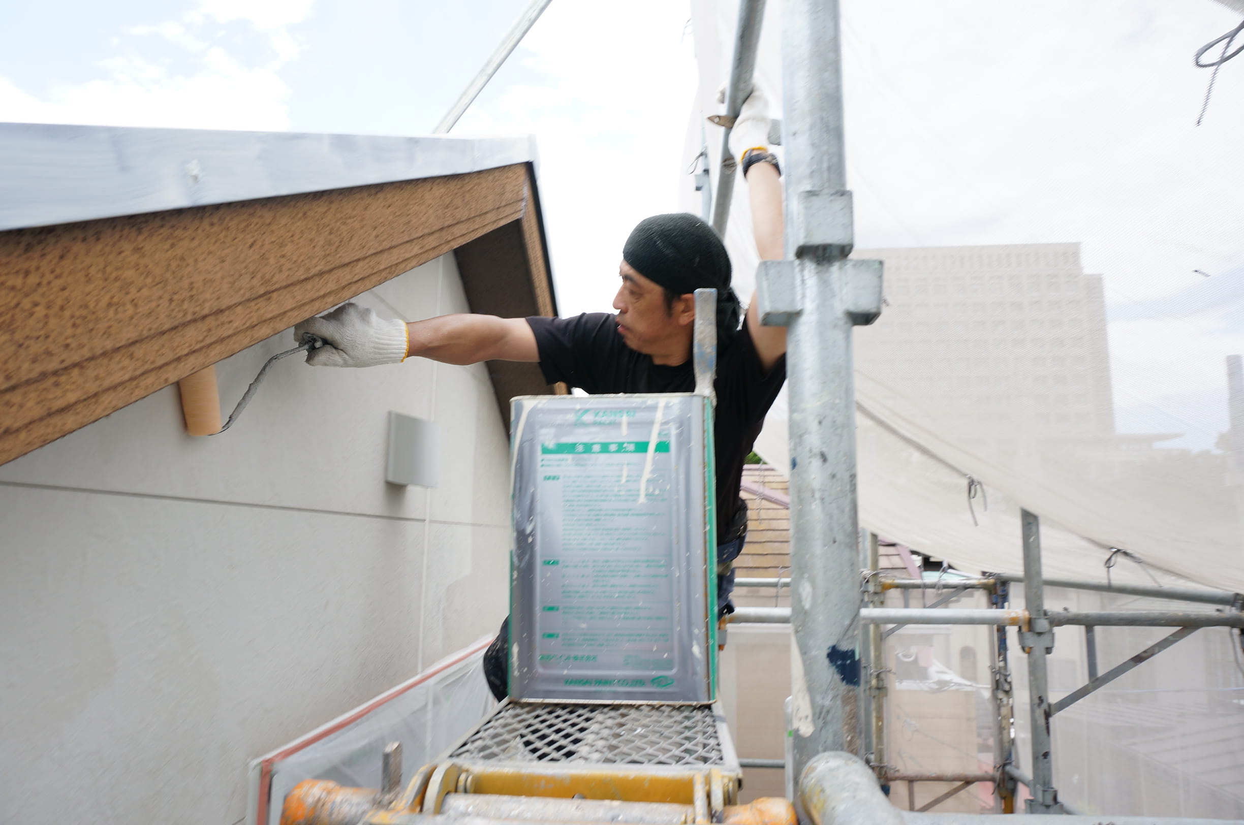 伊藤塗装の職人による軒天の塗装作業
